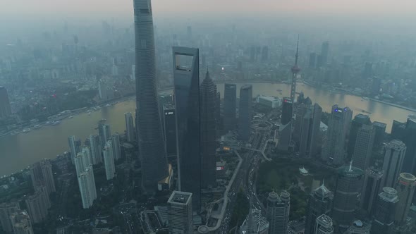 Aerial view of Shanghai skyline at sunset with mist, China.