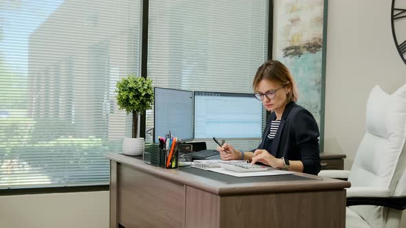 Woman Sit at Desk Using Computer Make Data Analysis Check Statistics Research Workday in Office