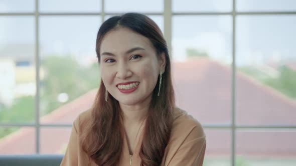 middle-aged Asian woman is greeting through video calls, She listened intently