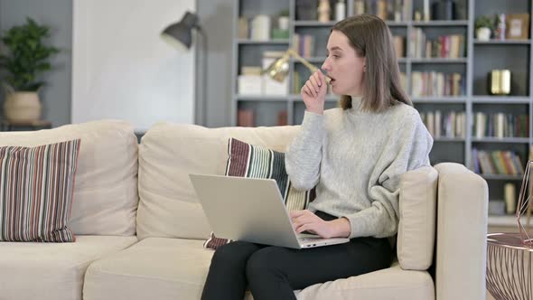 Sick Young Woman Coughing in Office