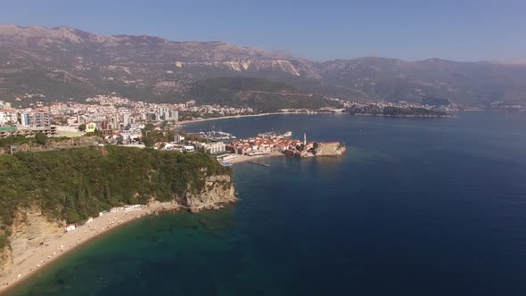 Drone View of the Town of Budva in the Bay of Kotor Against the Backdrop of Green Mountains
