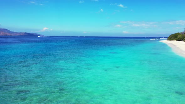 Island In Indonesia - Coral Reef Under The Clear Blue Sea Water Surrounding The Lush Island With Gre