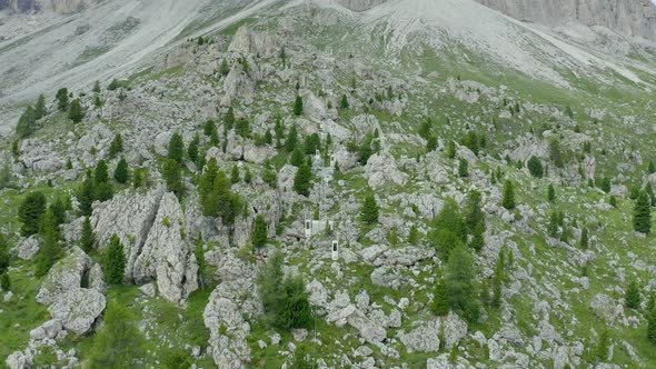 Aerial of mountain cable car climbing between rocky slopes, Dolomites