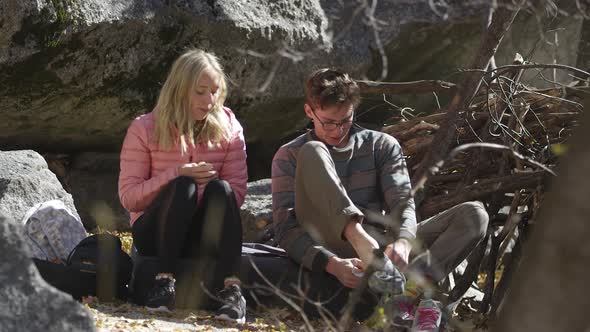 Young woman and man preparing to rock climb