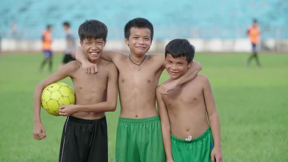 Kids Pose And Smile With A Soccer Ball alt