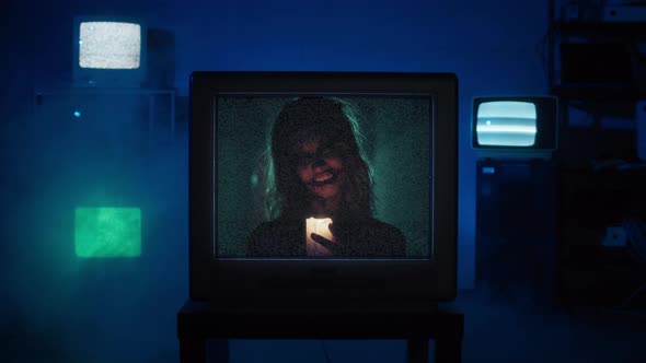 Old Tv Screen Showing Zombie Woman Holding Burning Candle Closeup