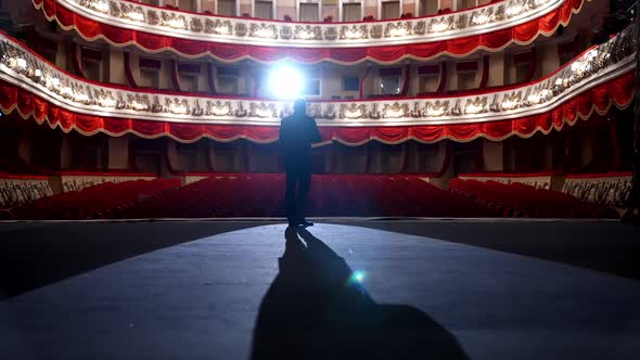 Empty raws in theater. Actor bows down in front of empty auditorium. 