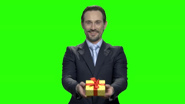 Middle Aged Man in Suit Giving You Gift