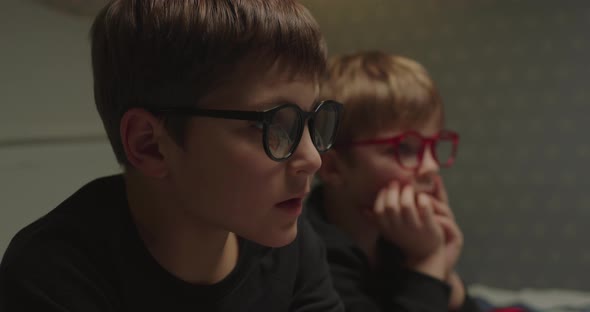 Two Brothers in Eyeglasses Watching Evening Movie Before Bedtime