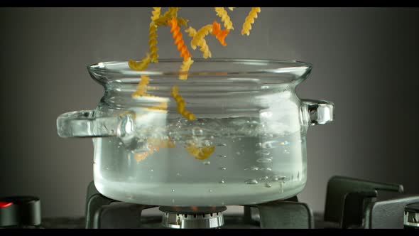 Super Slow Motion Shot of Fresh Fusilli Falling Into Boiling Salted Water at 1000 Fps