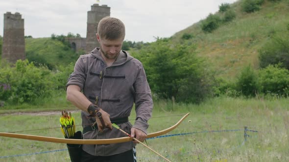 a Young Guy Shoots a Bow at a Target in Nature and Hits the Target the Arrow Pierces the Target for