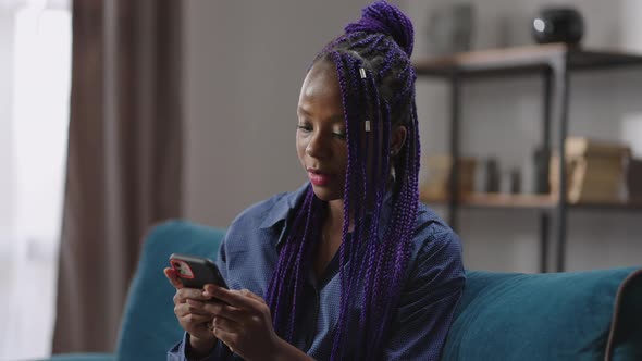 Young Black Lady is Chatting By Cell Phone Sending Message in Social Nets Surfing Internet Portrait