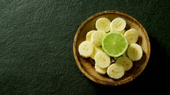 Lemon and sliced banana in a bowl 4k