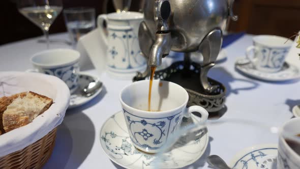 Traditional metal coffeepot with old fashioned porcelain