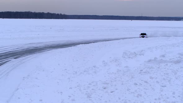 Aerial view of the rally car on a snowy road