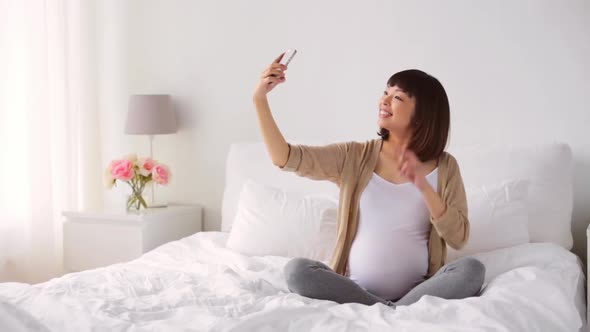 Pregnant Woman Taking Smartphone Selfie at Home
