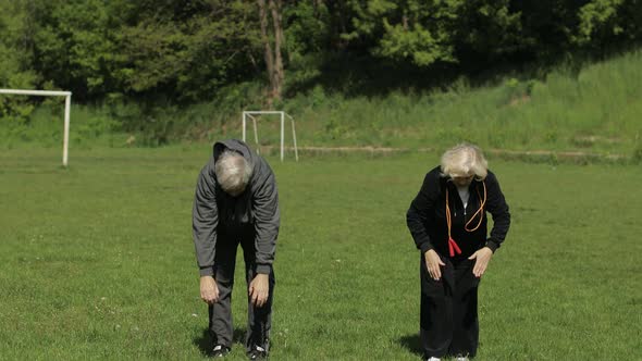 Active Senior Old Couple. Man and Woman Do Stretching Physical Exercises