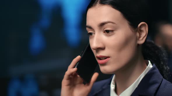 Closeup Face of Lady Financial Broker Communicating on Mobile Phone