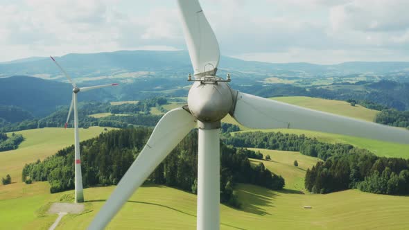 Zoom Out of Camera From a Propeller of the Windmill in the Field with Mountains on the Background