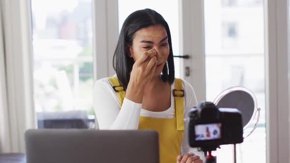 Mixed race gender fluid vlogger recording a make up vlog at home