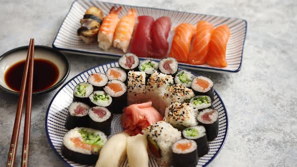 Asian Food Assortment. Various Sushi Rolls Placed on Ceramic Plates