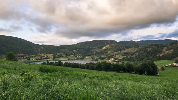 Timelapse of beautiful sunset seen from a green field in the country side of norway