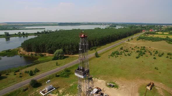 Drilling Tower in Forest. Gas Tower which is located in a field near the Lake.