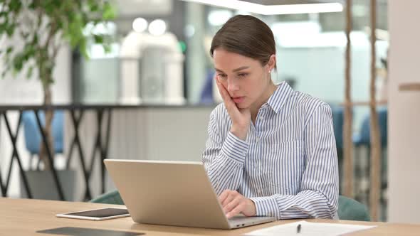 Young Woman Working on Laptop in Office 