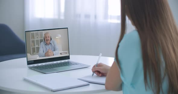 Distance Teacher Online Tutor Conferencing on Laptop Communicate with Pupil By Webcam Video Call