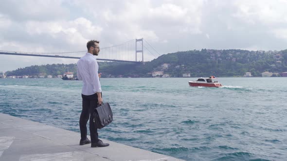 Businessman by the sea is thoughtful and pensive.