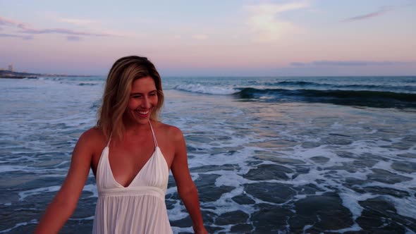 Attractive Woman Enjoying The Beach At Sunset