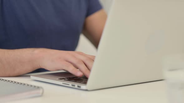 Close Up of Male Hands Typing on Laptop