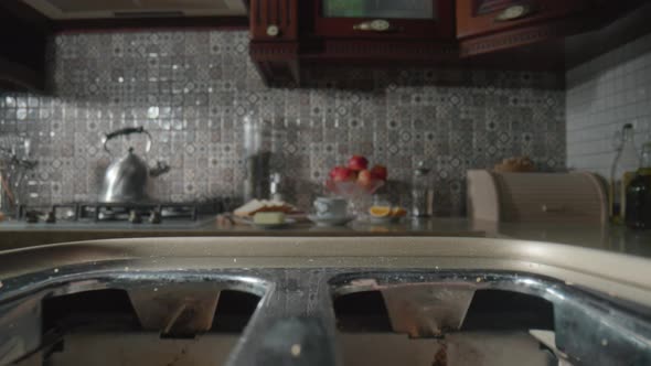 Sliced White Bread Popping Out of a Toaster on the Kitchen Table