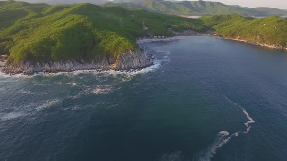 Aerial View of the Beautiful Sea Coast with Clear Blue Water at Sunset