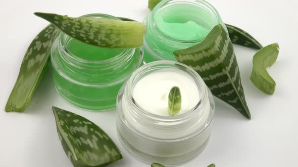 Cosmetics for skin care based on aloe Vera.  Jars of face cream are laid out on the white background