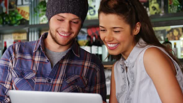 Couple using laptop in pub