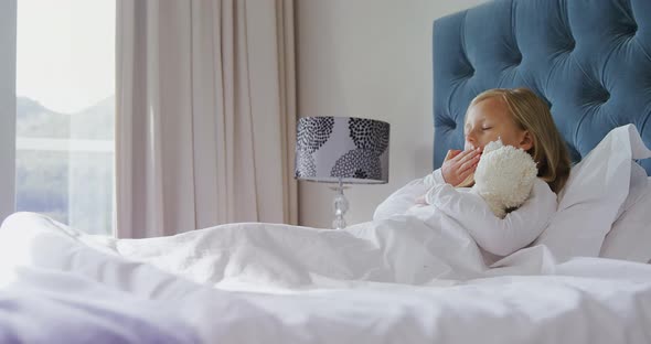 Girl stretching her arms while waking up in bedroom 4k