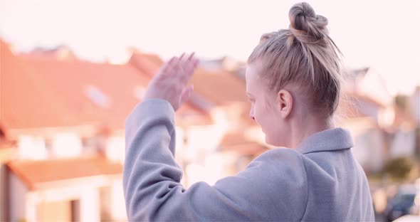 Woman Waving Hand At Rooftop