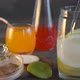 Preparation of Homemade Lemonade From Citrus Fruits Against the Background of Various Drinks - VideoHive Item for Sale