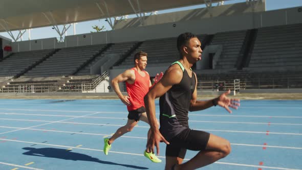 Two athletes running in stadium