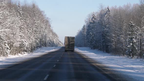 Truck Of Transport Company Driving In Winter On Highway Delivering Cargo