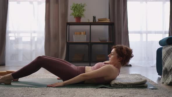 Woman in Sportswear is Finishing Yoga Training at Home and Lying on Floor Performing Shavasana