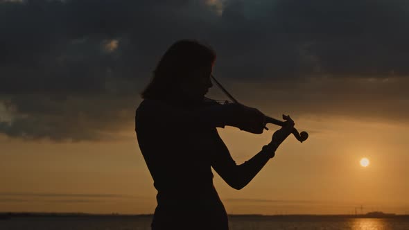 Silhouette of Young Woman Violinist