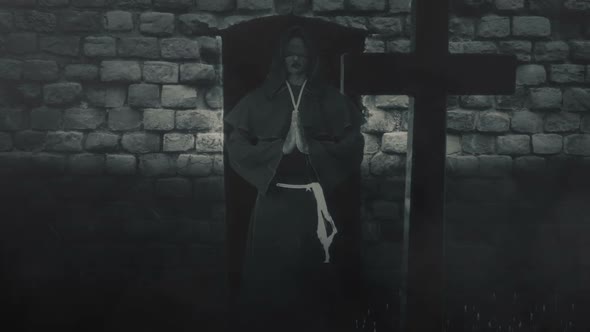 Catholic Blind Monk Holding Hand In Prayer In Front Of A Grave