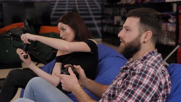 Smiling Couple Playing Video Games and Having Fun Together
