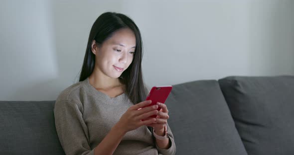 Woman use of mobile phone at home