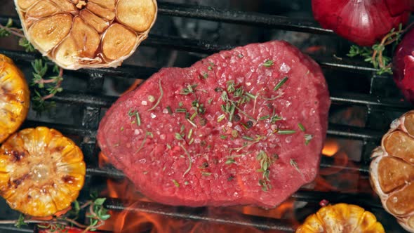 Super Slow Motion Top Shot of Fresh Beef Meat and Seasoning Falling on Grill at 1000 Fps