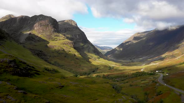 Scenic drone view of a road winding through highlands in Scotland near Glenco