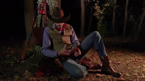 Cowboy with a Handgun in the Forest at Night