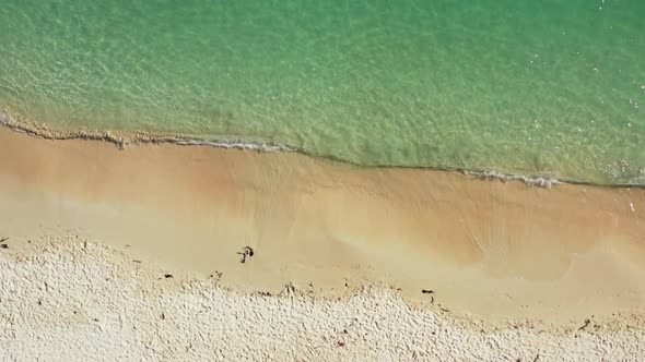 Aerial above travel of beautiful shore beach adventure by blue ocean with white sandy background of 